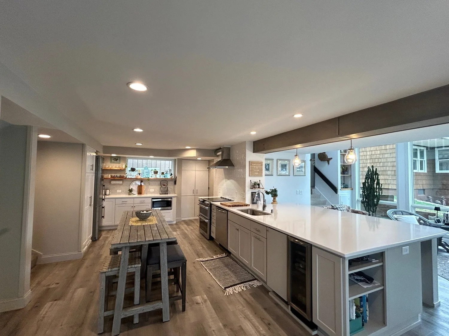 Vista kitchen with a long island, white cabinetry and daylight from a wall of windows
