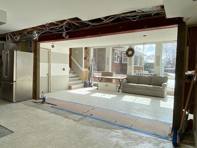 The opening after wall removal, with a header above the continuous view between rooms